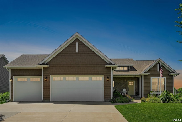 3563 Cobblestone Dr, Bettendorf, IA 52722 - view of front of home with a garage, driveway, a front yard, and roof with shingles