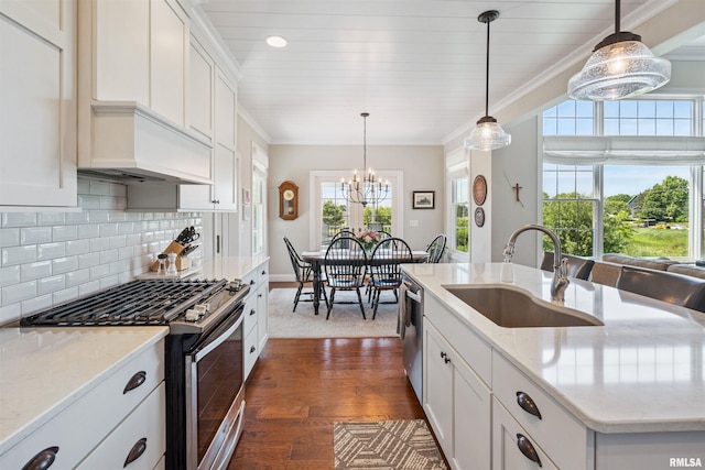 3563 Cobblestone Dr, Bettendorf, IA 52722 - kitchen with stainless steel appliances, a chandelier, dark wood-style flooring, decorative backsplash, and white cabinetry
