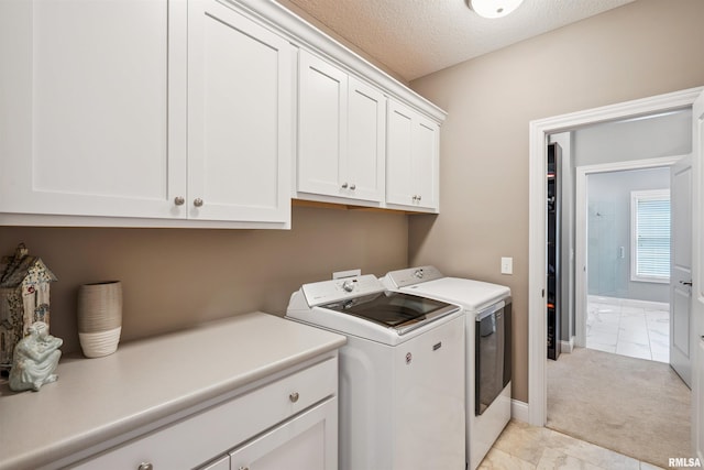 3563 Cobblestone Dr, Bettendorf, IA 52722 - laundry room with cabinet space, washer and dryer, a textured ceiling, and light colored carpet