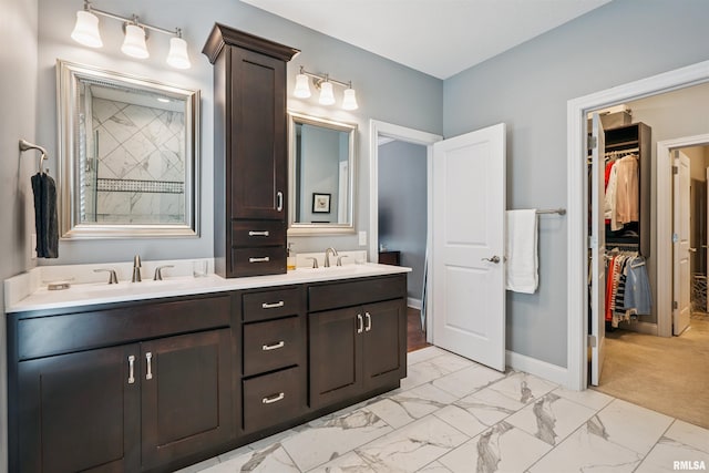 3563 Cobblestone Dr, Bettendorf, IA 52722 - bathroom with double vanity, a spacious closet, and marble look tiles