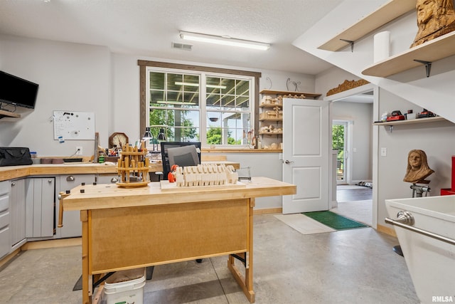 3563 Cobblestone Dr, Bettendorf, IA 52722 - kitchen with open shelves, healthy amount of natural light, wood counters, and a textured ceiling