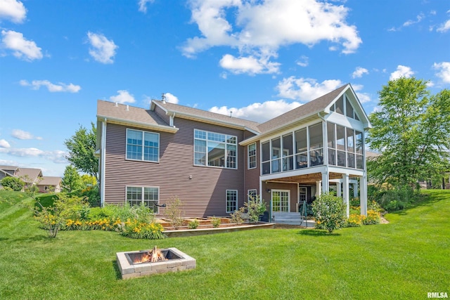 3563 Cobblestone Dr, Bettendorf, IA 52722 - back of property featuring an outdoor fire pit, a sunroom, and a lawn