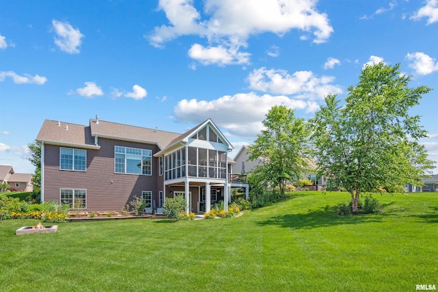 3563 Cobblestone Dr, Bettendorf, IA 52722 - back of house with a sunroom and a lawn
