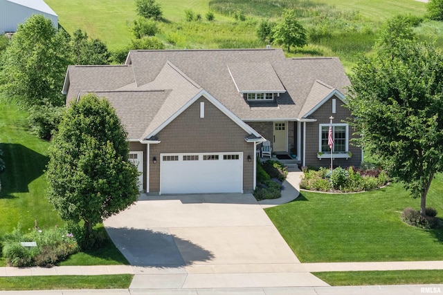 3563 Cobblestone Dr, Bettendorf, IA 52722 - view of front facade featuring driveway, a front yard, a shingled roof, and an attached garage