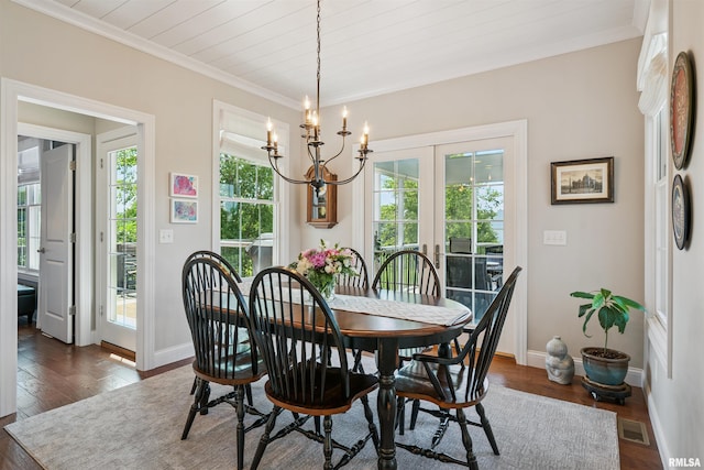 3563 Cobblestone Dr, Bettendorf, IA 52722 - dining space with plenty of natural light, a chandelier, dark wood-type flooring, ornamental molding, and french doors