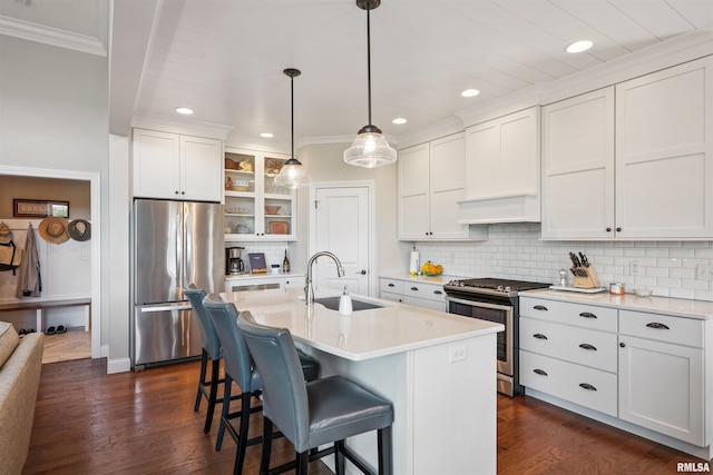 3563 Cobblestone Dr, Bettendorf, IA 52722 - kitchen with stainless steel appliances, ornamental molding, custom range hood, a breakfast bar, and light countertops