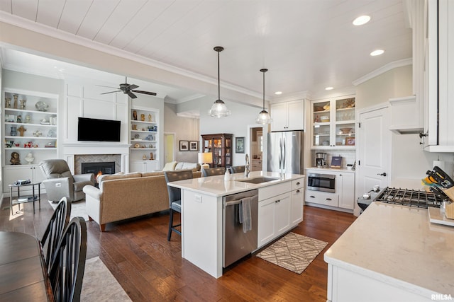 3563 Cobblestone Dr, Bettendorf, IA 52722 - kitchen with appliances with stainless steel finishes, ceiling fan, recessed lighting, dark wood-style floors, and a kitchen breakfast bar