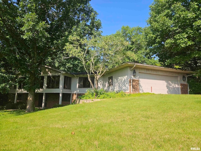 28003 230th St, Le Claire, IA 52753 - view of green lawn with an attached garage