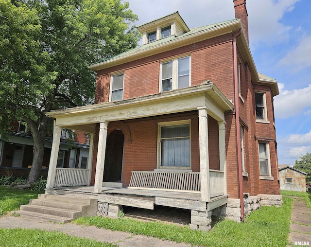 710 N 12th St, Quincy, IL 62301 - traditional style home with covered porch, brick siding, and a chimney