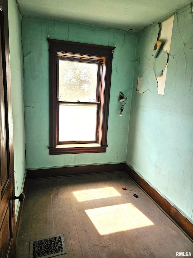 710 N 12th St, Quincy, IL 62301 - spare room featuring plenty of natural light and wood finished floors