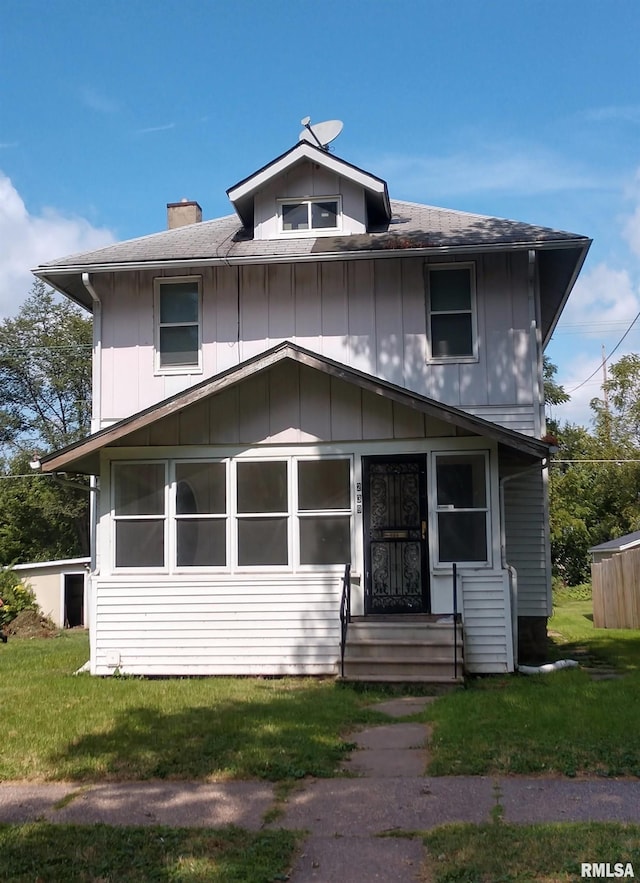 239 15th Ave, East Moline, IL 61244 - traditional style home featuring entry steps, a chimney, roof with shingles, and a front lawn
