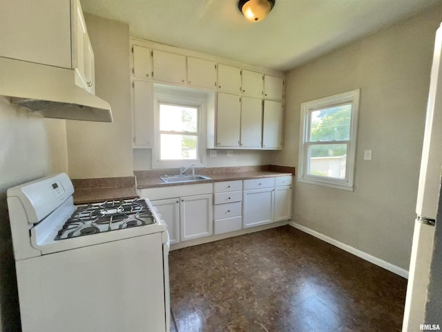 239 15th Ave, East Moline, IL 61244 - kitchen with white range with gas cooktop, under cabinet range hood, healthy amount of natural light, and white cabinetry