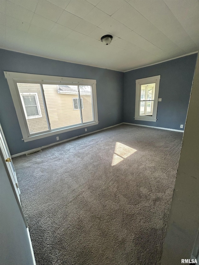 239 15th Ave, East Moline, IL 61244 - spare room featuring carpet flooring and baseboards
