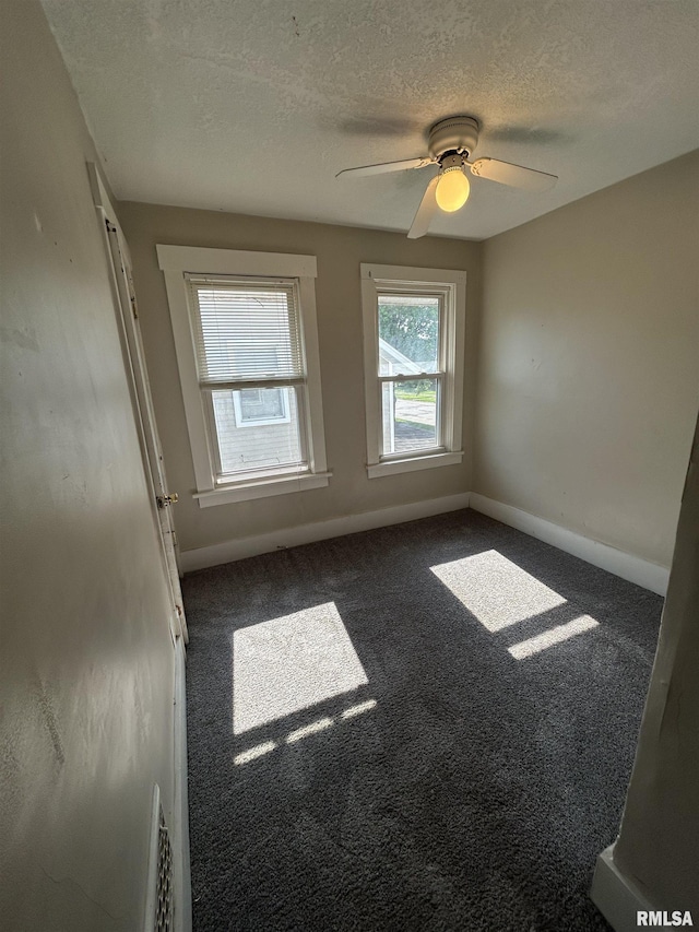 239 15th Ave, East Moline, IL 61244 - carpeted spare room featuring a textured ceiling and ceiling fan