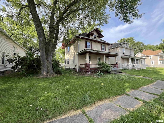 421 W 17th St, Davenport, IA 52803 - american foursquare style home featuring a porch and a front lawn