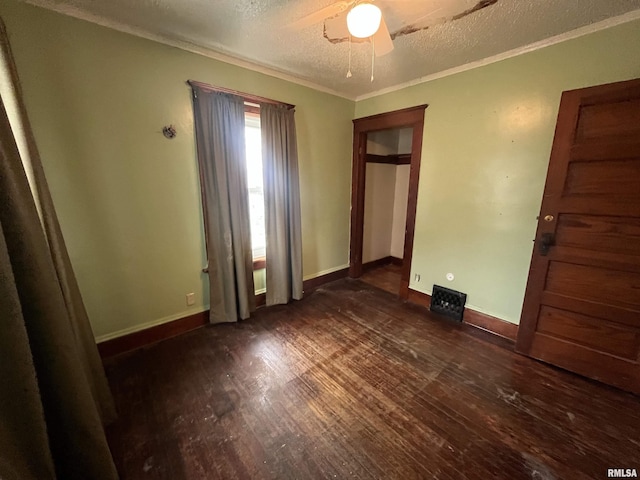 421 W 17th St, Davenport, IA 52803 - unfurnished bedroom with a textured ceiling, dark wood-type flooring, ornamental molding, and a ceiling fan