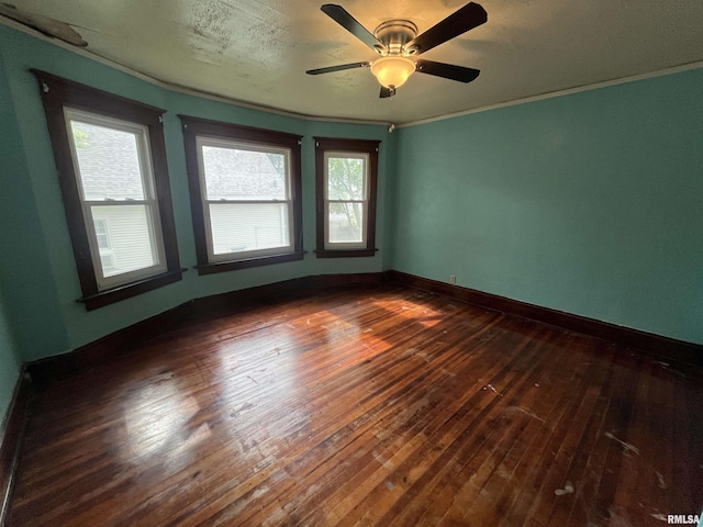 421 W 17th St, Davenport, IA 52803 - empty room with dark wood-type flooring, plenty of natural light, ornamental molding, and ceiling fan