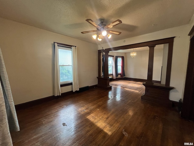 421 W 17th St, Davenport, IA 52803 - unfurnished room featuring a textured ceiling, decorative columns, a ceiling fan, wood finished floors, and a chandelier