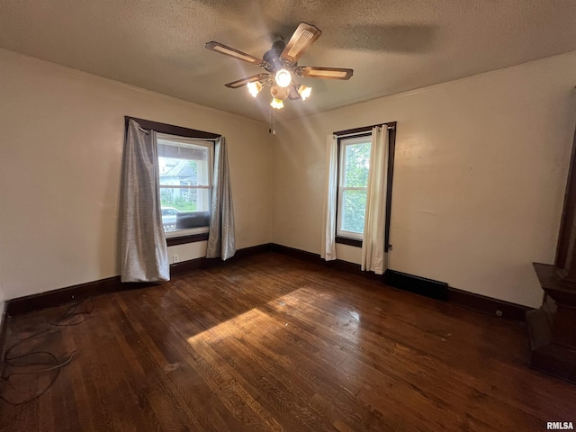 421 W 17th St, Davenport, IA 52803 - spare room featuring dark wood finished floors, a textured ceiling, and a ceiling fan