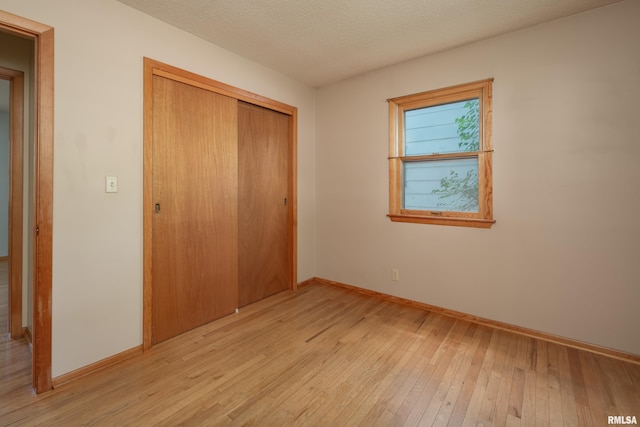 3403 Kimberly Downs Rd, Davenport, IA 52807 - unfurnished bedroom with light wood finished floors and a closet