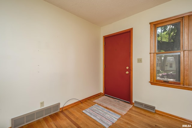 3403 Kimberly Downs Rd, Davenport, IA 52807 - entryway with wood finished floors and a textured ceiling