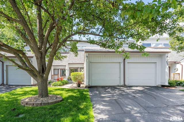493 44th Avenue Ct, East Moline, IL 61244 - view of front of home featuring a garage, a front yard, and asphalt driveway