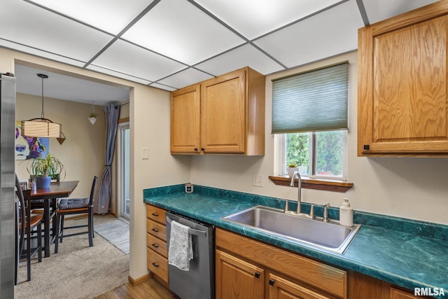 493 44th Avenue Ct, East Moline, IL 61244 - kitchen featuring appliances with stainless steel finishes, dark countertops, light wood-style flooring, and hanging light fixtures
