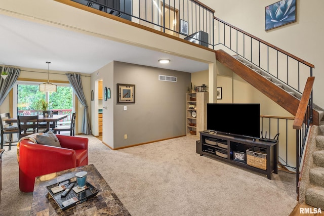 493 44th Avenue Ct, East Moline, IL 61244 - carpeted living room featuring stairway and baseboards