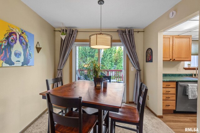 493 44th Avenue Ct, East Moline, IL 61244 - dining space featuring baseboards and light wood-style floors