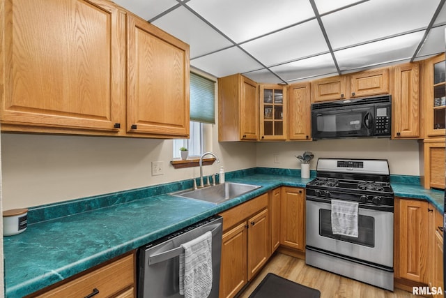493 44th Avenue Ct, East Moline, IL 61244 - kitchen with appliances with stainless steel finishes, dark countertops, light wood-type flooring, and glass insert cabinets