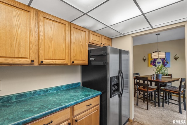 493 44th Avenue Ct, East Moline, IL 61244 - kitchen with stainless steel fridge with ice dispenser, dark countertops, light colored carpet, and decorative light fixtures