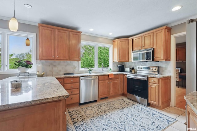4444 Spring St, Davenport, IA 52807 - kitchen featuring appliances with stainless steel finishes, ornamental molding, tasteful backsplash, light tile patterned flooring, and light stone countertops