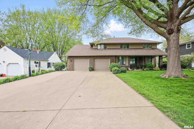 4444 Spring St, Davenport, IA 52807 - view of front facade with an attached garage, driveway, brick siding, a front lawn, and covered porch