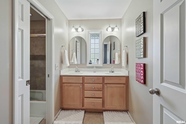 4444 Spring St, Davenport, IA 52807 - full bath with double vanity, tile patterned flooring, and bath / shower combo with glass door