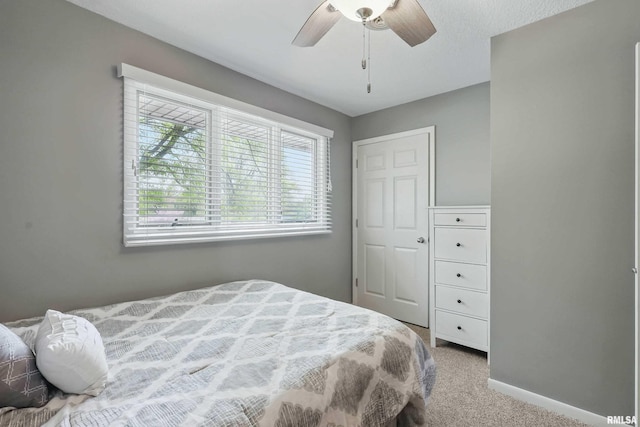 4444 Spring St, Davenport, IA 52807 - carpeted bedroom with baseboards and ceiling fan