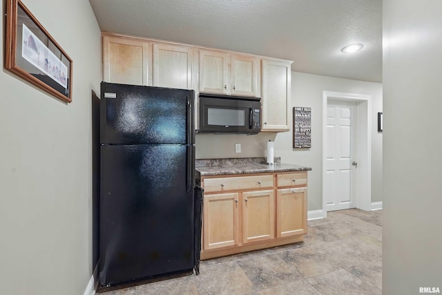 4444 Spring St, Davenport, IA 52807 - kitchen featuring black appliances, light brown cabinetry, and a textured ceiling