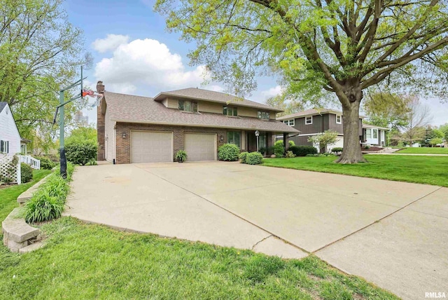4444 Spring St, Davenport, IA 52807 - view of front facade featuring an attached garage, a front yard, a chimney, brick siding, and driveway