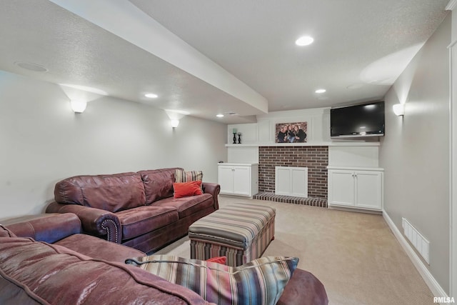 4444 Spring St, Davenport, IA 52807 - living area featuring light carpet, recessed lighting, a fireplace, and a textured ceiling