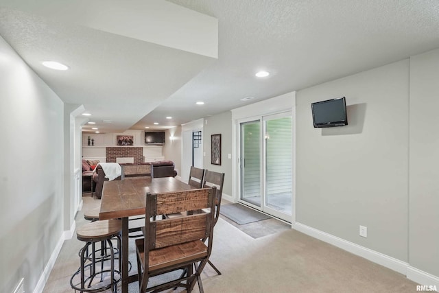 4444 Spring St, Davenport, IA 52807 - dining room with a brick fireplace, light colored carpet, recessed lighting, and a textured ceiling