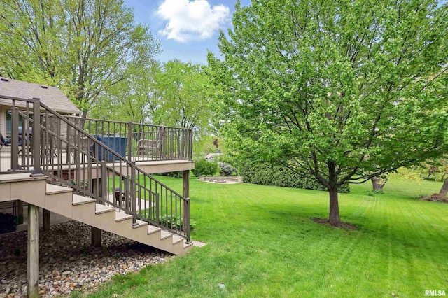 4444 Spring St, Davenport, IA 52807 - view of grassy yard with stairs and a deck