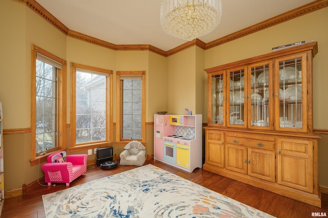 4934 Foxborough Ct, Bettendorf, IA 52722 - rec room featuring a chandelier, wood finished floors, and ornamental molding