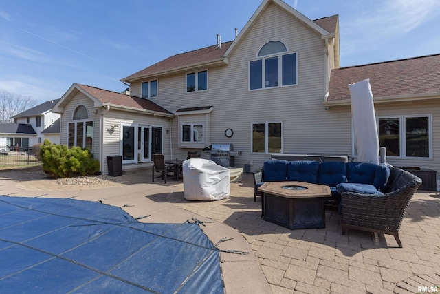 4934 Foxborough Ct, Bettendorf, IA 52722 - rear view of property featuring a patio, an outdoor living space with a fire pit, and roof with shingles
