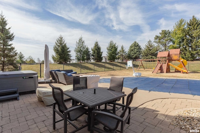 4934 Foxborough Ct, Bettendorf, IA 52722 - fenced backyard featuring a hot tub, a patio area, a playground, and outdoor dining space