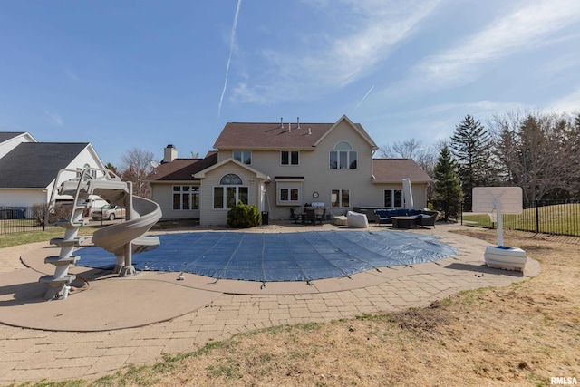 4934 Foxborough Ct, Bettendorf, IA 52722 - view of pool featuring a patio area, an outdoor hangout area, and a water slide