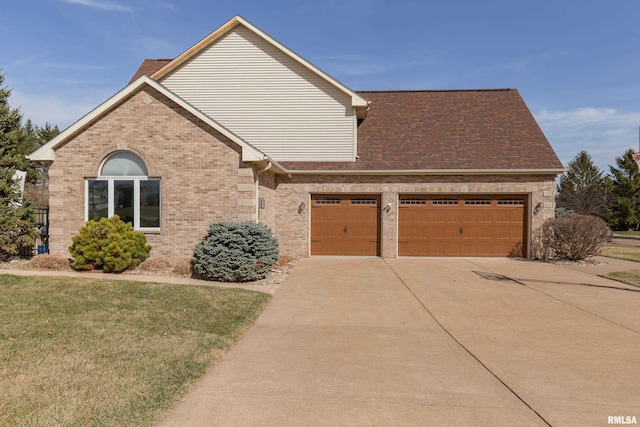 4934 Foxborough Ct, Bettendorf, IA 52722 - view of front facade with concrete driveway, brick siding, a front lawn, and a garage