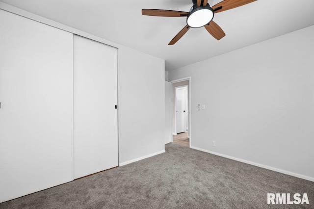 3040 Oak Street Ct, Bettendorf, IA 52722 - unfurnished bedroom featuring carpet, a closet, and ceiling fan