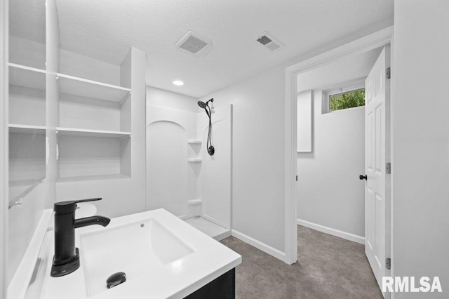 3040 Oak Street Ct, Bettendorf, IA 52722 - full bathroom featuring a shower, vanity, and a textured ceiling