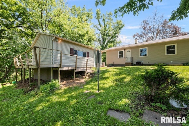 3040 Oak Street Ct, Bettendorf, IA 52722 - back of property featuring a deck, a lawn, and a chimney