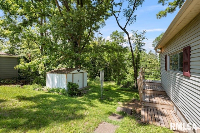 3040 Oak Street Ct, Bettendorf, IA 52722 - view of green lawn with a shed and a wooden deck
