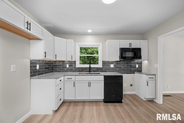3040 Oak Street Ct, Bettendorf, IA 52722 - kitchen with black appliances, light wood-style flooring, white cabinetry, backsplash, and light stone countertops